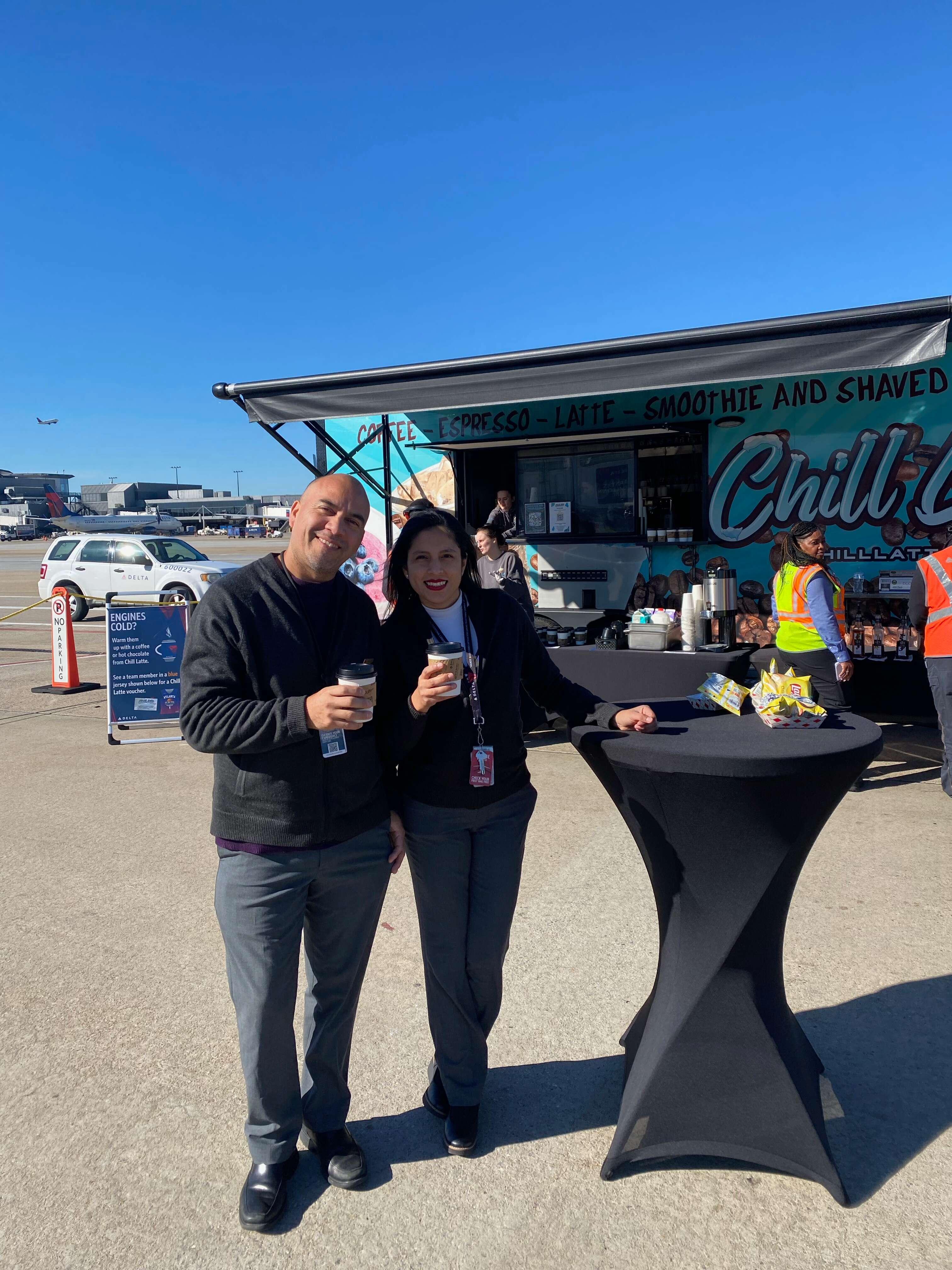Delta employees at Delta airport with Chill Latte coffee cups 