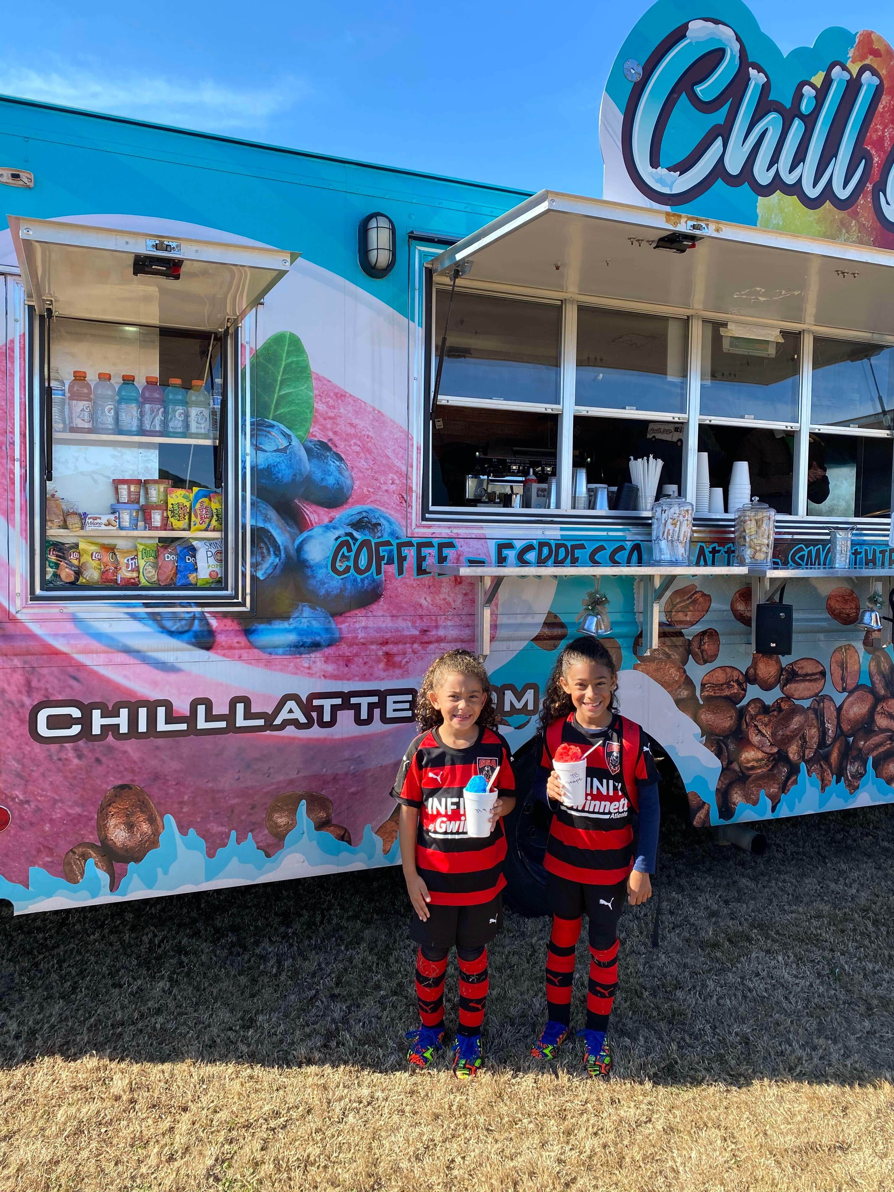 two soccer girls posing with chill latte shaved ice 