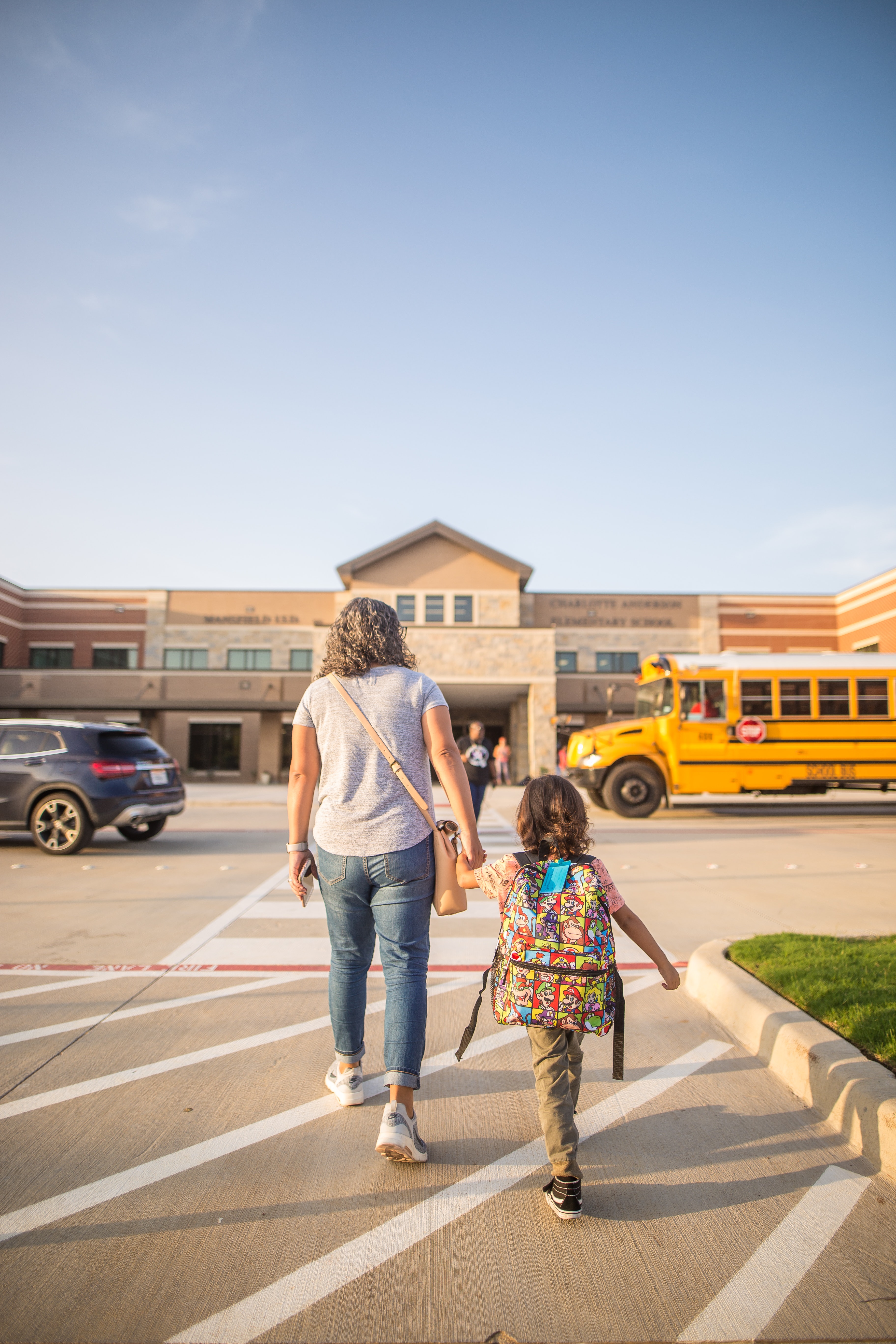 Picture of a school mom and daughter walking to school 